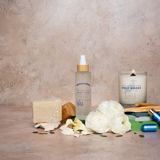 Ritual bundle products including a room spray, candle, inhaler and soap on a textured surface with a neutral background