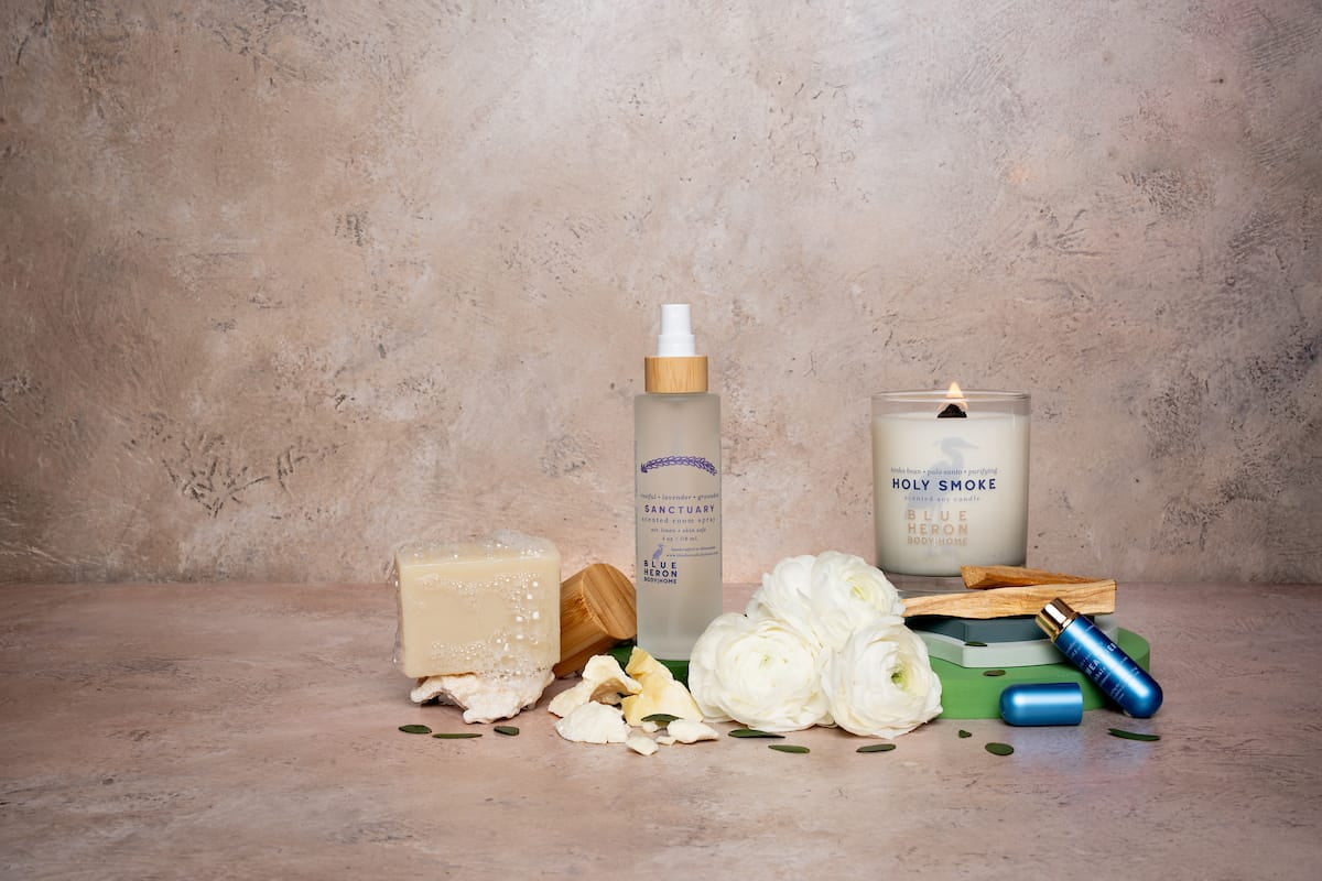 Ritual bundle products including a room spray, candle, inhaler and soap on a textured surface with a neutral background