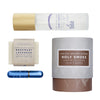 Collection of natural products including a candle, soap, room spray and inhaler on a white background